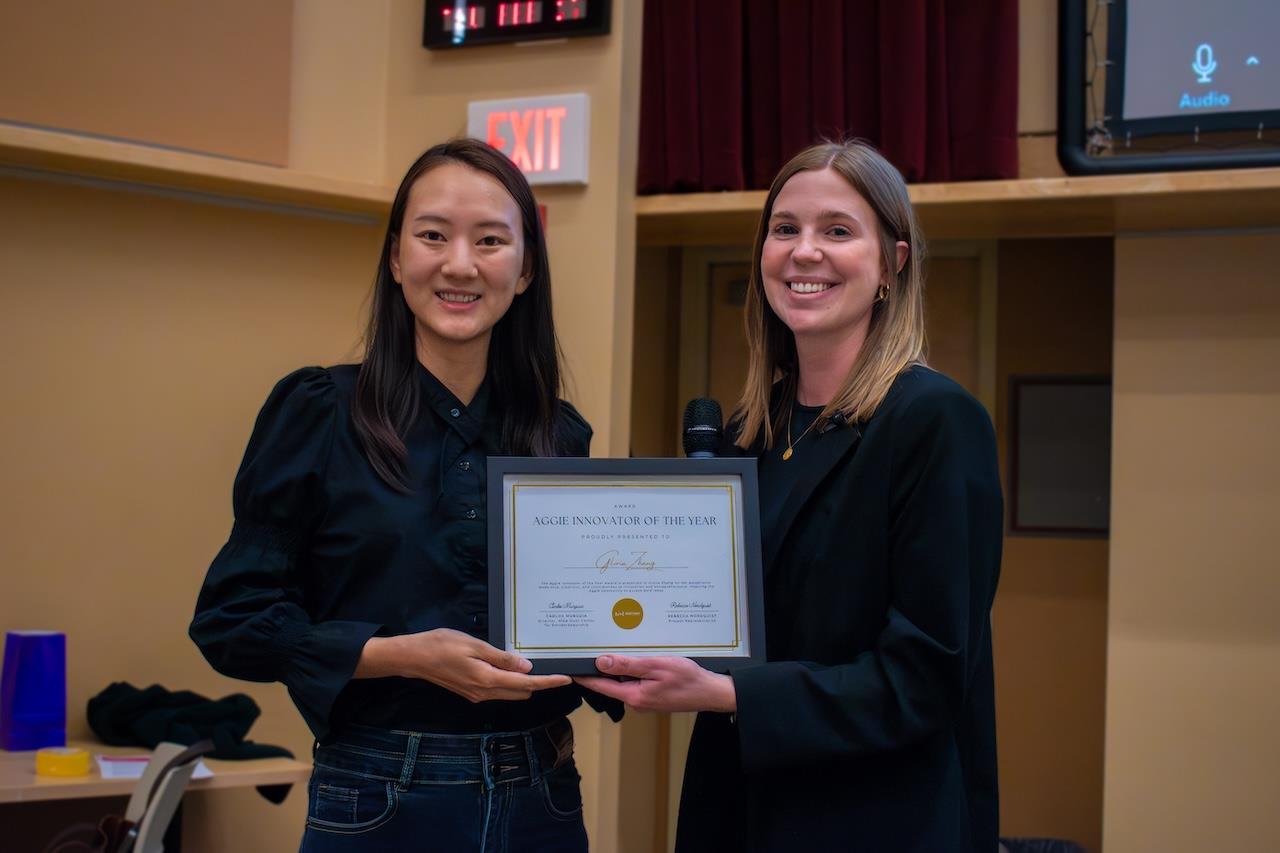 Two women holding a plaque.